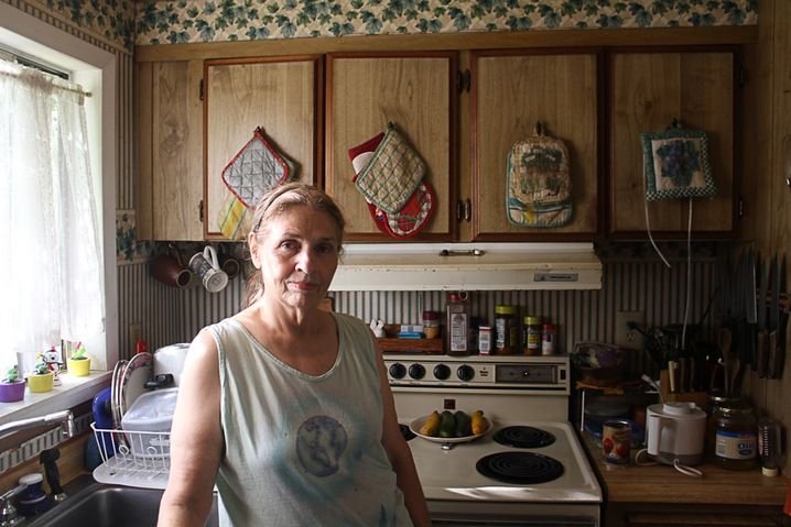 Homeowner standing in her kitchen