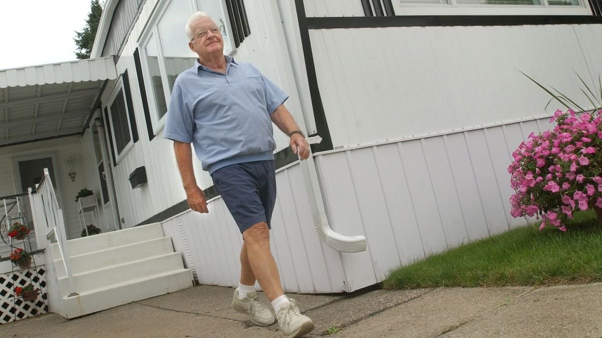 Homeowner outside his manufactured home